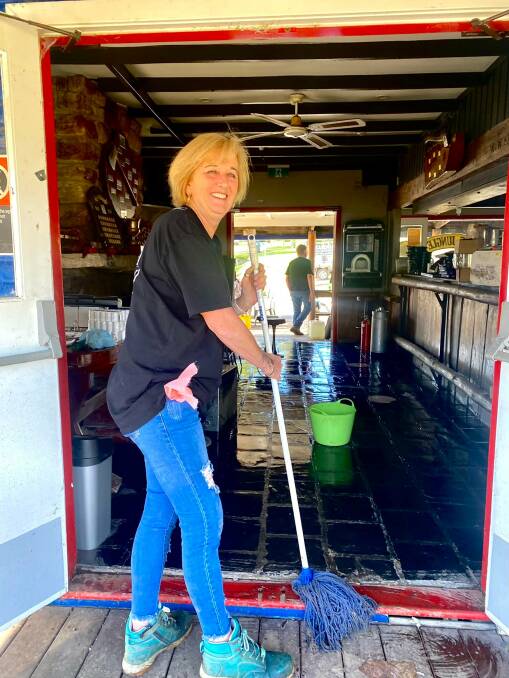 BIG JOB: Wollombi Tavern owner Cathie Books gets stuck into the clean-up with a smile. Picture: Charlie McLennan