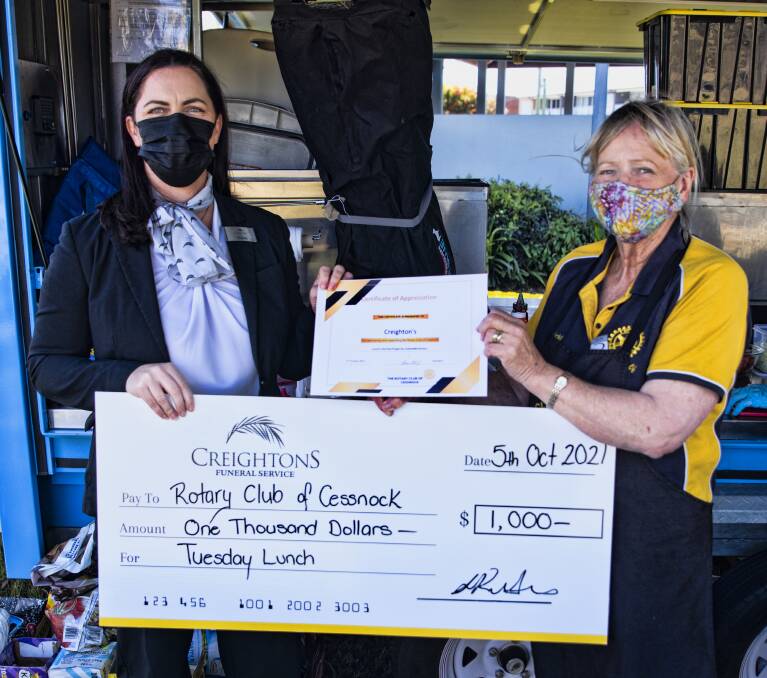 SUPPORT: Nicole Kutyanov from Creightons Funeral Service hands over the donation to Cessnock Rotary Club president Vicki Steep. Picture: George Koncz