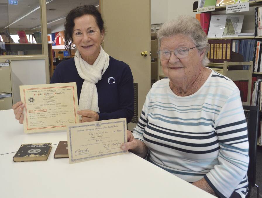 DONATION: Cessnock Library's local studies librarian Kimberly O'Sullivan with Gloria Wallace, who donated her mother's National Emergency Services training certificates and textbooks to the library.