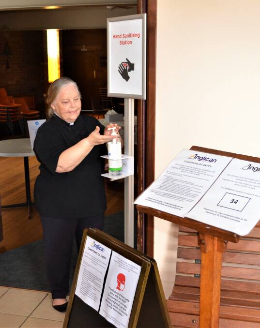 HYGIENE: Reverend Robin Lewis-Quinn at St John's Anglican Church, Cessnock, where parishioners are required to use hand sanitiser on entry.
