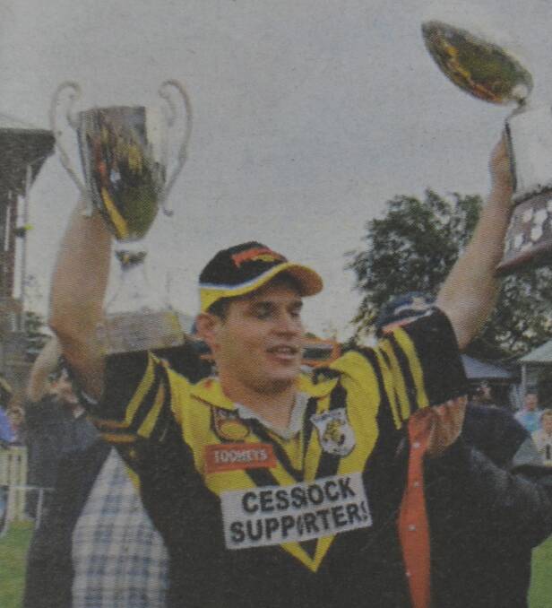 AT LAST: Goannas captain-coach Daniel Smailes holds the trophies high after the 2003 win, the club's first premiership in 26 years.