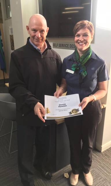 'ABOVE AND BEYOND': Chamber president Allan Davies presents April winner Donna Howson with her award. NOTE: Award presented before mask-wearing measures were introduced.