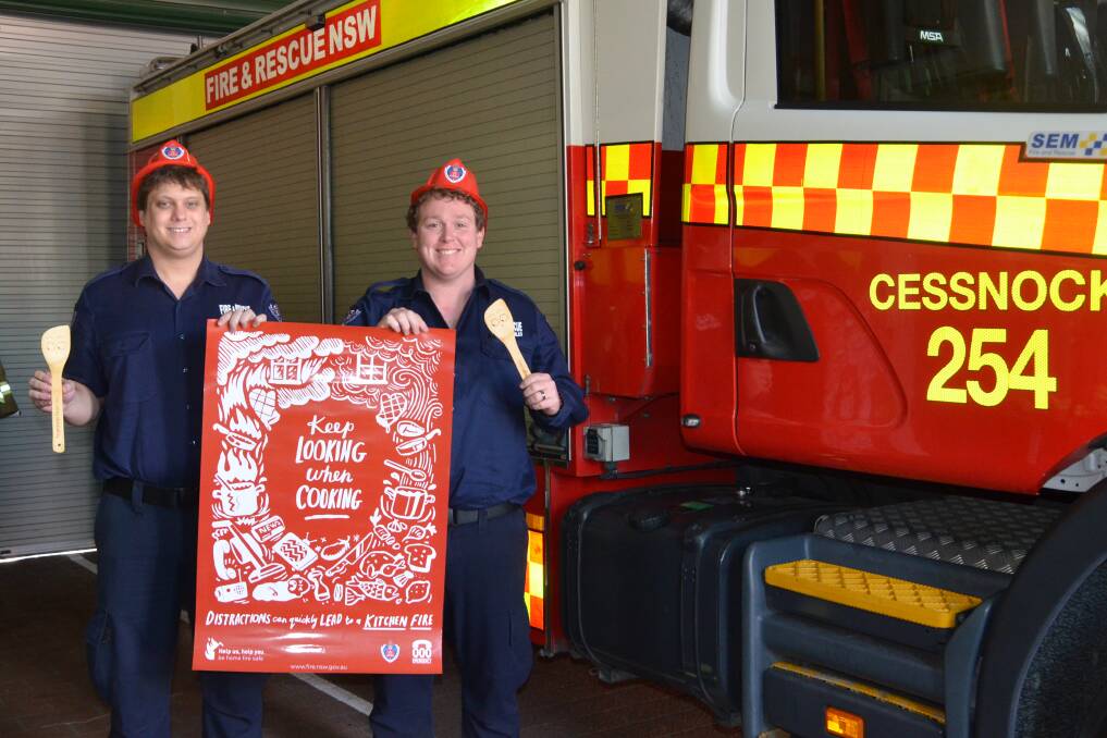 AWARENESS: Cessnock firefighters Jamie Chapple and Ben Allen with a poster promoting the theme of this year's open day. Picture: Krystal Sellars