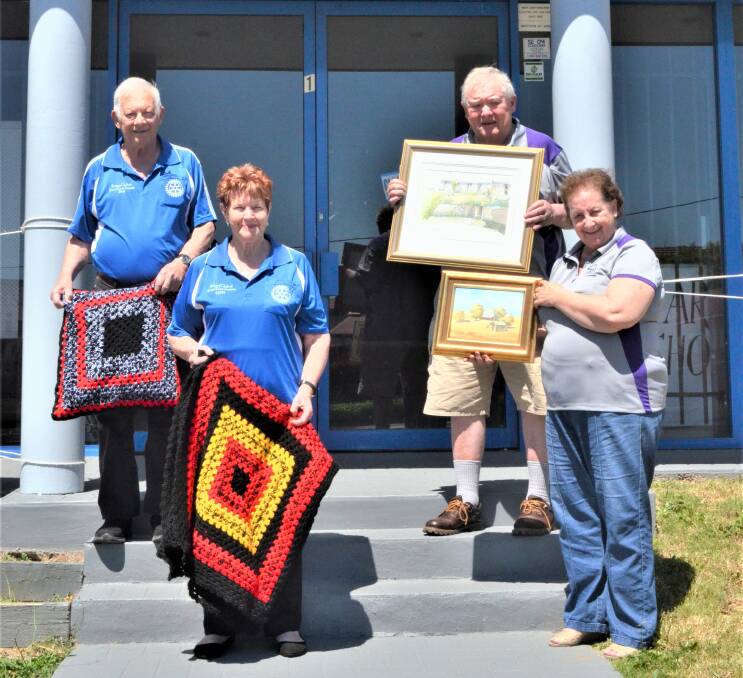 JOINT EVENT: Kurri Sunrise Rotary members Des and Lynn Mills and Towns With Heart's Graham Smith and Sharon Dyson-Smith getting ready for the art and craft festival.