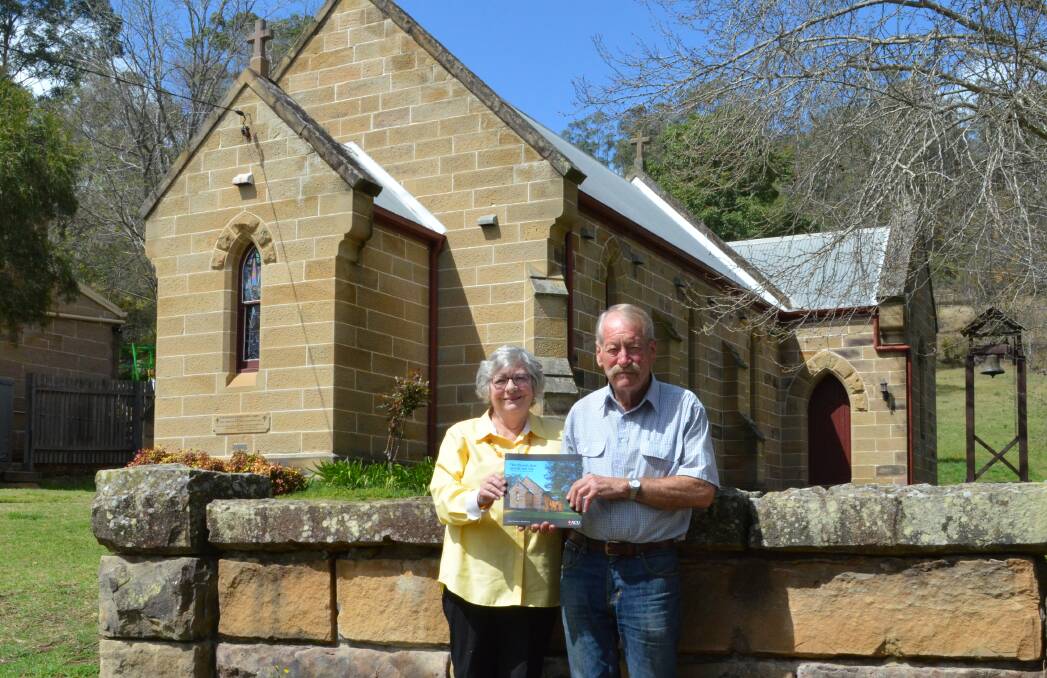 FASCINATING HISTORY: The book's co-author Gael Winnick, with Daryl Heslop, who was the inaugural president of the Friends of St Michael's, outside the Wollombi church.