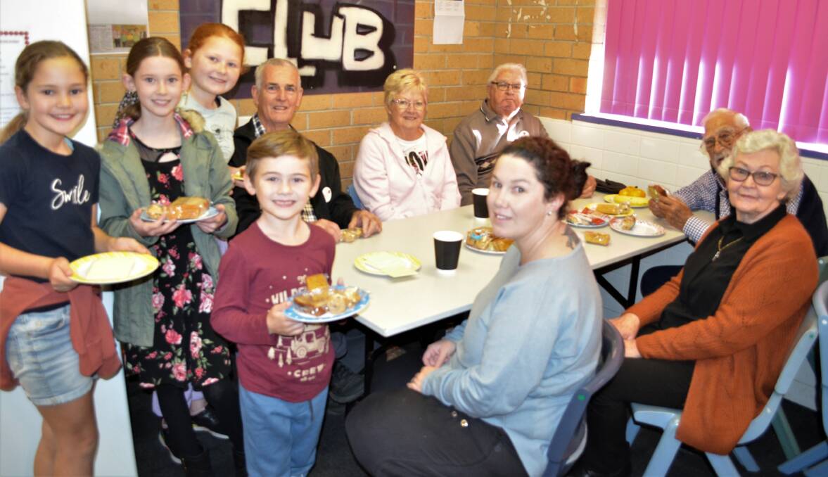 WELCOME BACK: Cessnock Public School students Pippa, Kandace, Sophie and Jaxson with breakfast club volunteers Dennis Moore, Cheryl Moore, Kimberly Orchard, Frank Southam, Keith Woollett and Christine Morris.