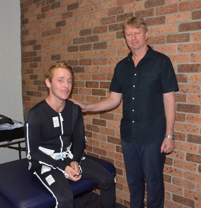 NEW TECHNOLOGY: Callan tries the Mollii suit with occupational therapist Greg Donelly at Total Fitness Cessnock last Thursday. Picture: Krystal Sellars