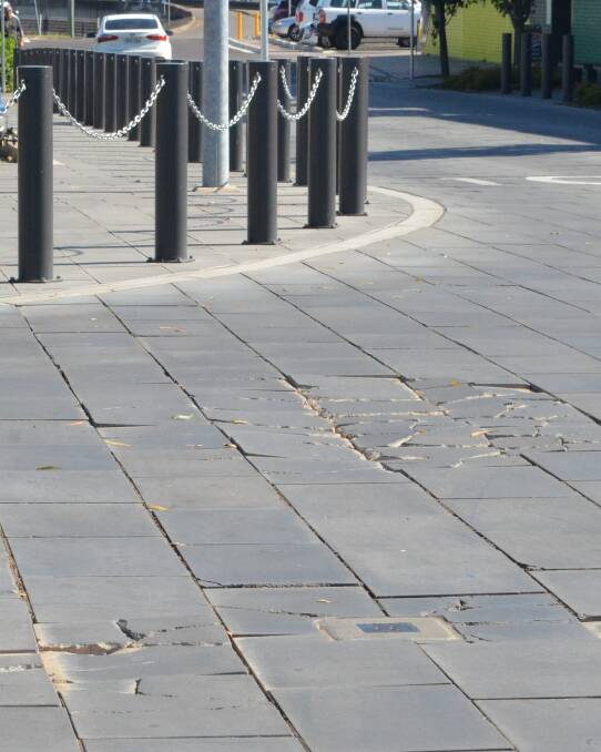 BROKEN: Cracked pavers at the intersection of Cooper and Charlton Streets, Cessnock.
