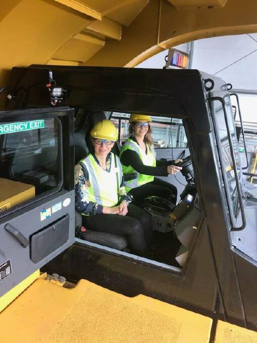 VISIT: Megan and Julie-Anne from Jodie's Place on board a truck at Glencore's Bulga Coal open cut mine on July 3, when representatives of the refuge toured the mine.