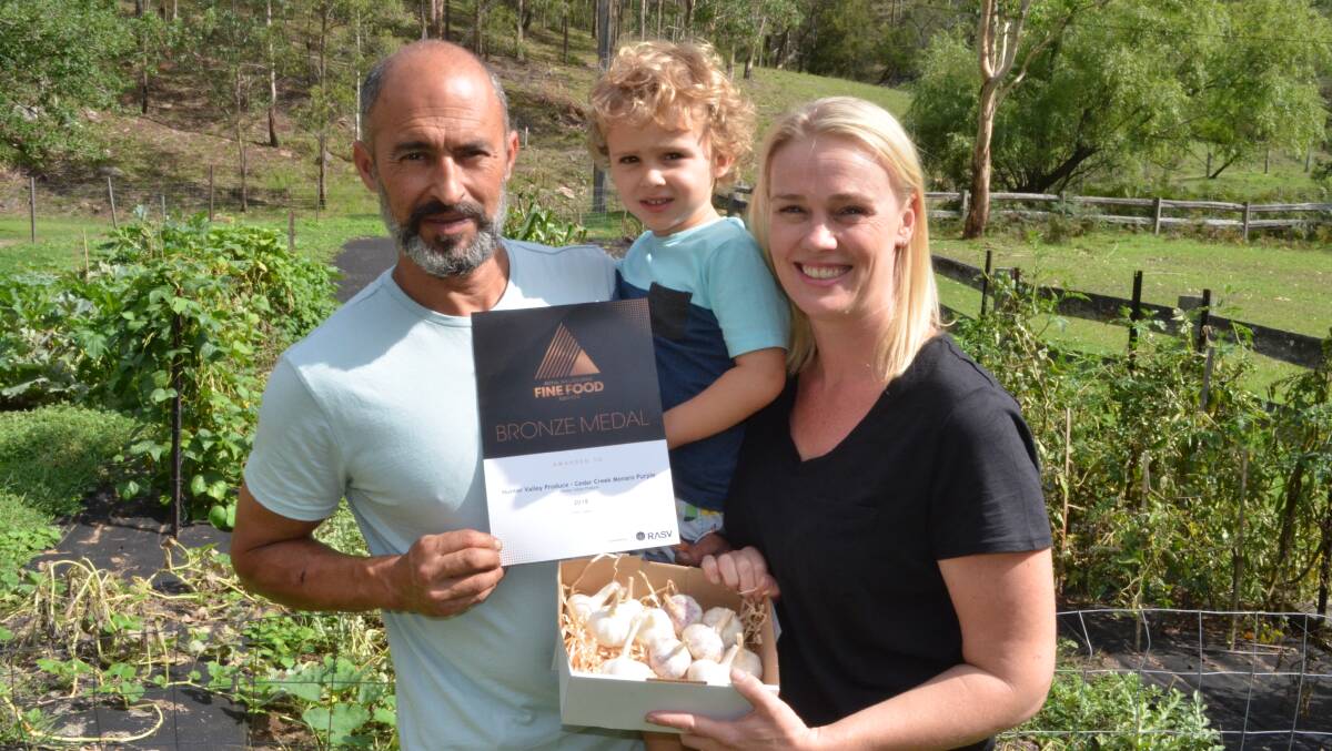 BRONZE MEDAL: Hunter Valley Produce owners Jeremy Aoun and Amber Sheedy and their son Zane, 3, with their award-winning garlic. Picture: Krystal Sellars