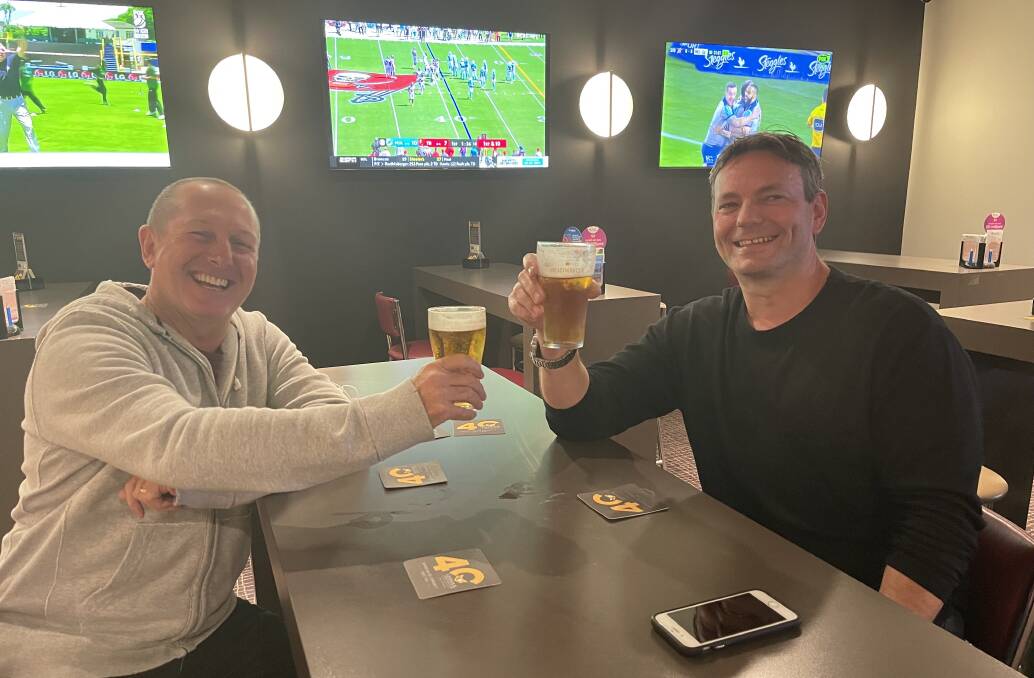 CHEERS: Bobby Eleigh-Schwartz and Phil McCafferty enjoy a 'freedom day' beer at Cessnock Leagues Club.