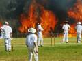ICONIC IMAGE: Darren Pateman's Walkley-award winning photograph of the cricket match that took place at Cessnock as the bushfire approached in October 2002.