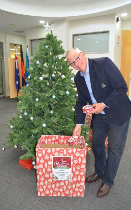 HELPING PEOPLE IN NEED: Cessnock mayor Bob Pynsent with some donations for council's Christmas Gift and Food Appeal.