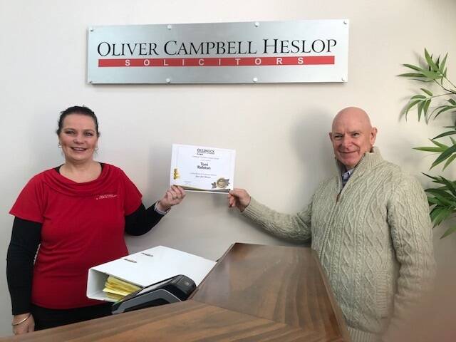 FINALIST: Toni Ralston of Oliver Campbell Heslop Solicitors receives the monthly award for June from Cessnock Business Chamber president Allan Davies. NOTE: Award presented before mask-wearing measures were introduced.