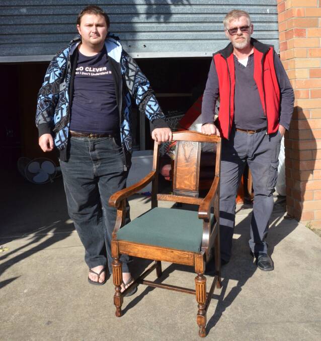 RARE PAIR: ADRA Op Shop volunteers Jesse Young and Sam Wilson with the 'king' chair, whose 'queen' was stolen from the shop's storage shed over the weekend.