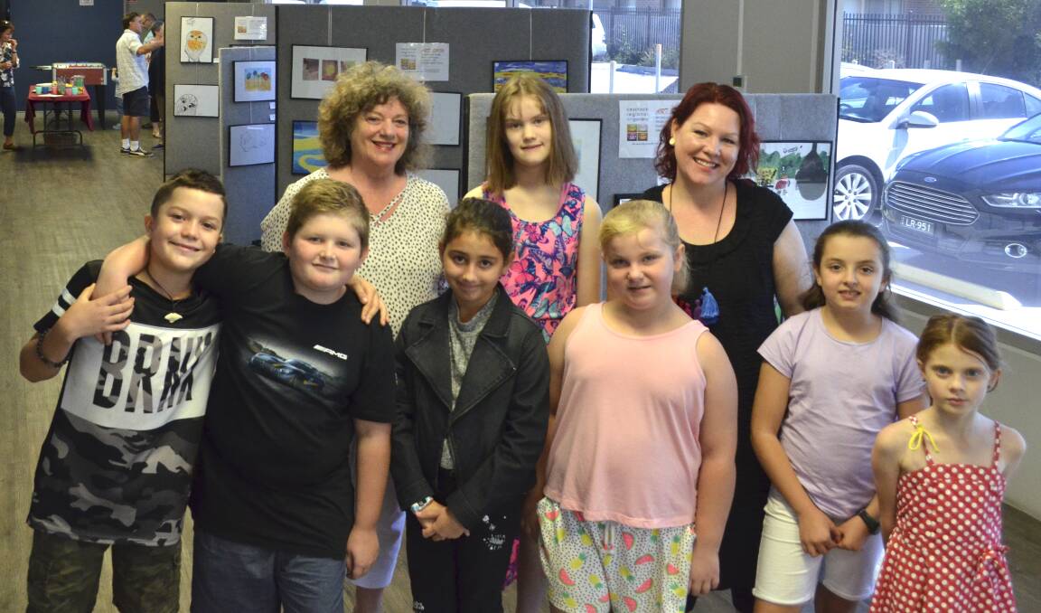 PROUD: Cessnock Regional Art Gallery artist educators Katrina Rose and Emmie Hallett with some of their students at the exhibition opening at PCYC Cessnock on Friday.