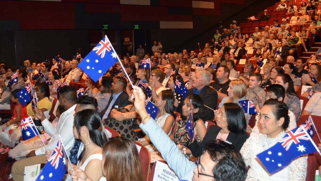 CELEBRATION: The crowd waves flags at Cessnock's 2020 Australia Day ceremony.