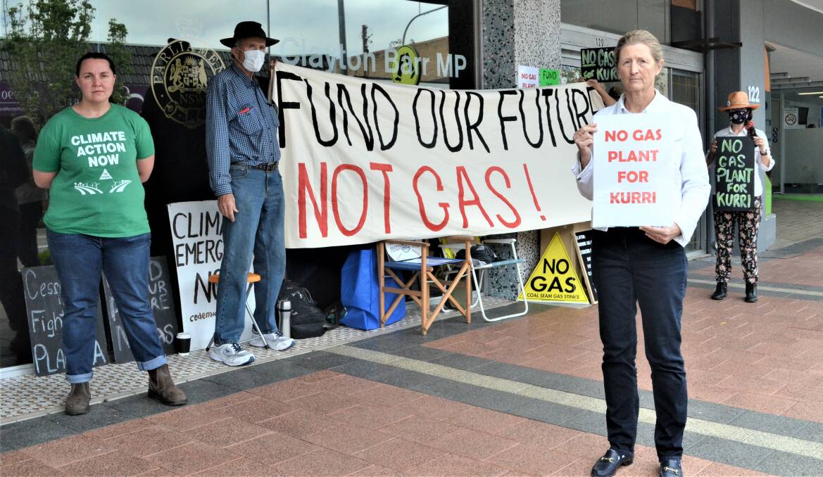 TIME FOR RENEWABLES: Janet Murray (front) and members of Coalfields for Climate Action protesting outside Cessnock MP Clayton Barr's office on Friday.