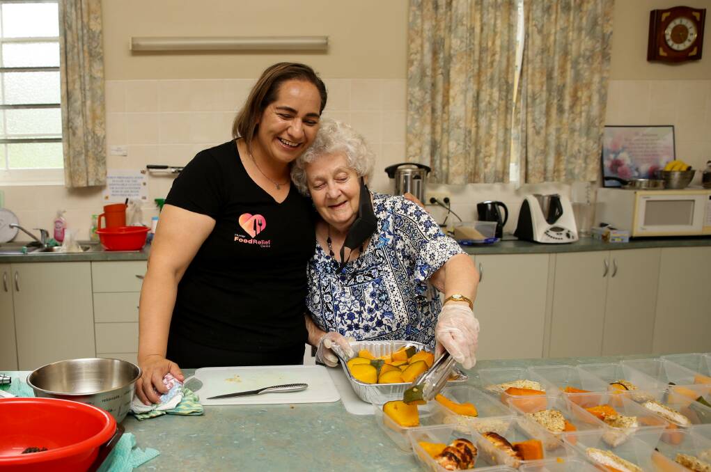 HERE TO HELP: Hunter Food Relief Centre coordinator Georgina Grine, with volunteer Cynthia, prepping meals at Cessnock Uniting Church. Picture: Jonathan Carroll