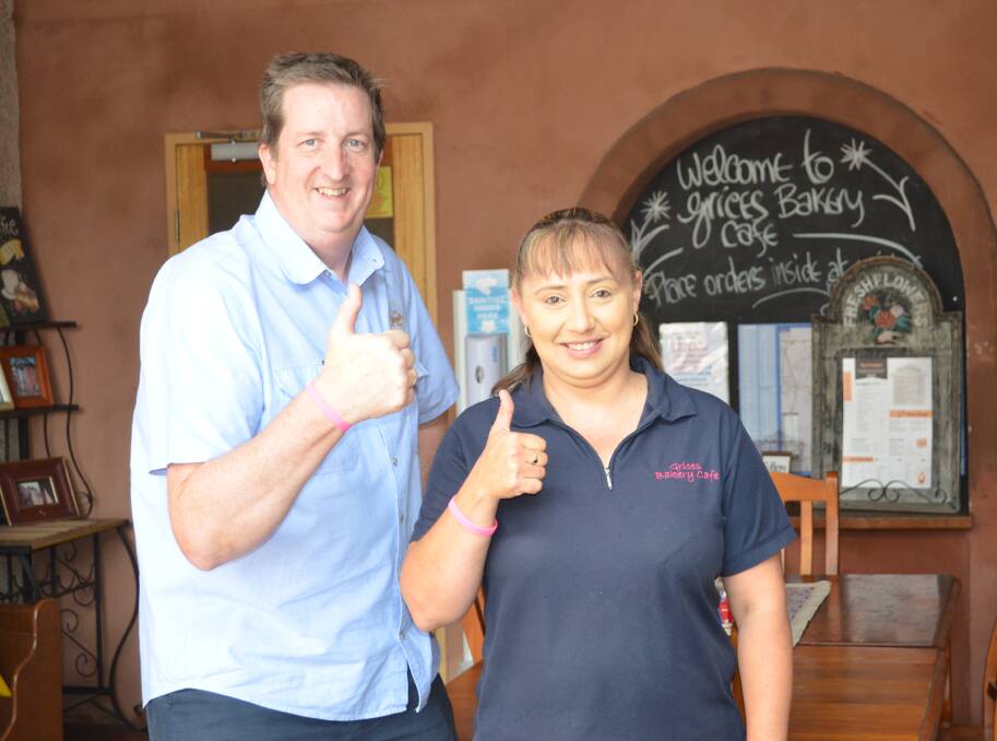 SUCCESS: Cessnock Bicycle Company owner Steve Whitby and Grice's Bakery and Cafe owner Kelly Hall, wearing their #PinkScones wristbands.