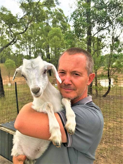 FARM LIFE: Todd Alexander with one of the countless goats at his Belford property. The best-selling author will speak at Cessnock Library on February 11.