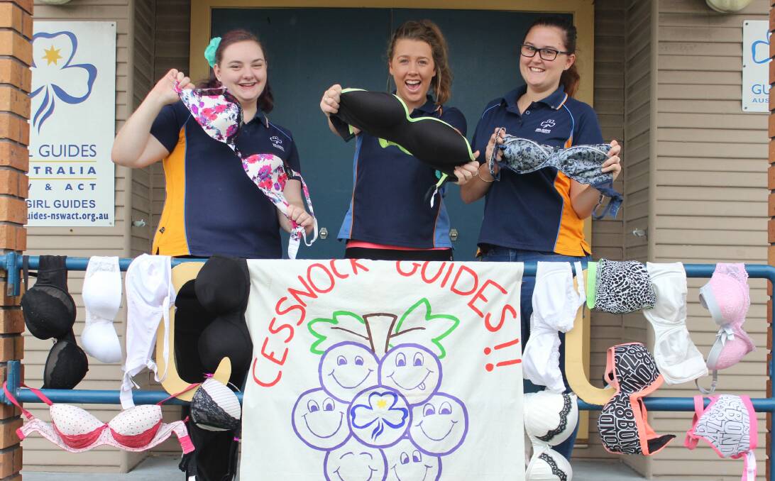 SUPPORT: Cessnock Girl Guides Olaves unit members Ainslie Griffin, Lauren Gray and Olivia Rice with some of the bras they have collected for the Uplift Project. Picture: SARAH DONN 