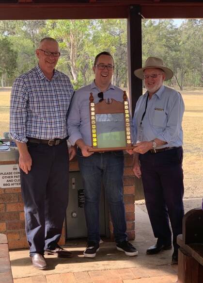 HONOUR: Cessnock mayorr Bob Pynsent handing over the Tidy Towns award to Councillor Josh Brown and Ron Campbell from Murrurundi.