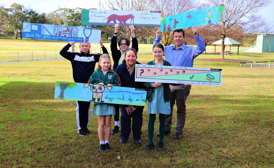 MESSAGE: Design competition winners Annabelle Manktelow, Imogen Forster, Brooklyn Christe and Tahlia Wright with Cessnock City Council youth services coordinator Megan Harbrow and mayor Jay Suvaal. Absent: Alice Pearce
