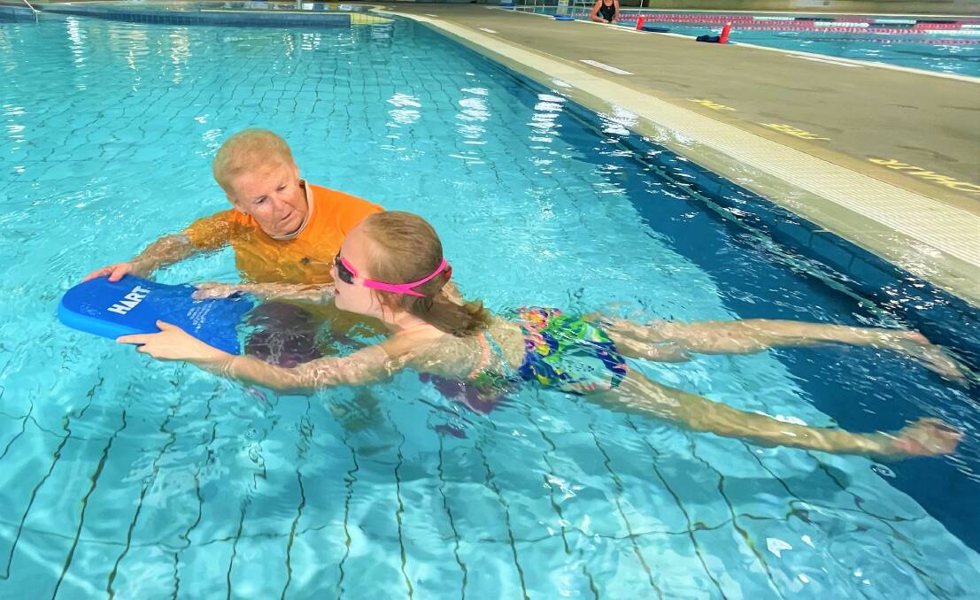 UNSTOPPABLE: Ellena Morris (pictured with Stella Mascord at Kurri Aquatic Centre) teaches swimming 50-to-60 hours between Cessnock, Kurri and Valentine pools.