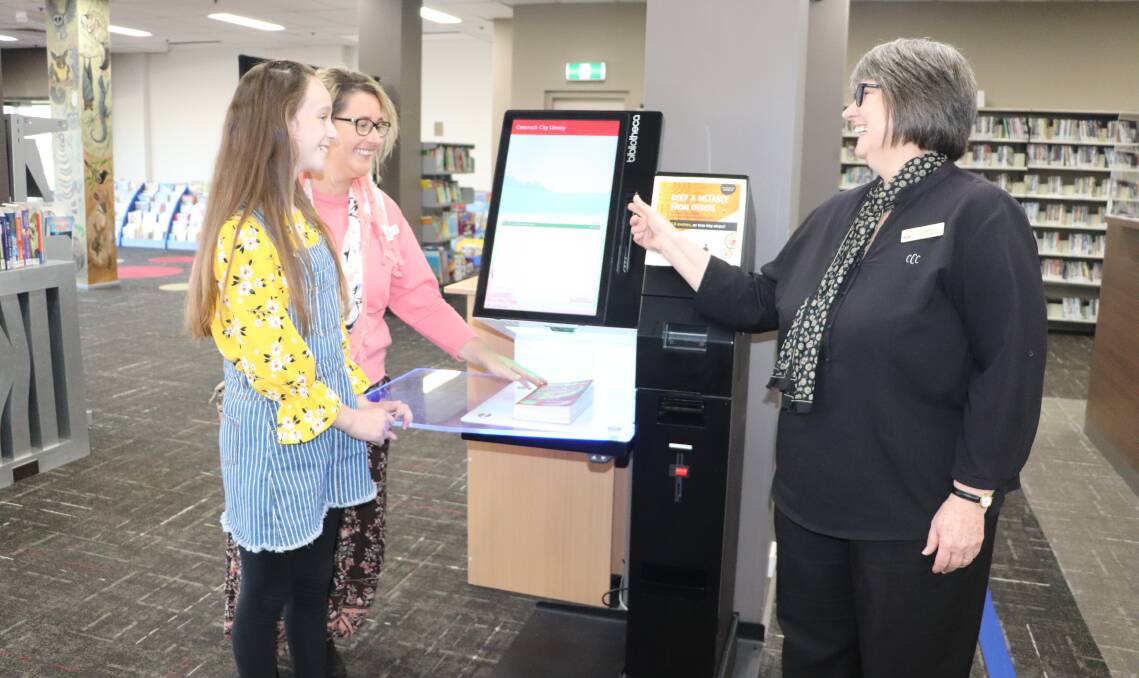 SERVICE: Kurri Kurri Library team leader Karen Bruce shows Chelsea and Noni Stewart how to use the self-serve checkout.