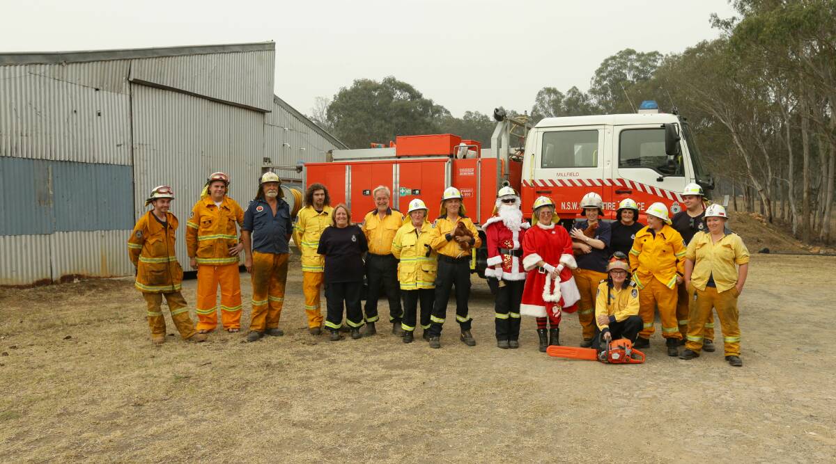 DEDICATED: Millfield RFS volunteers, who have put in more than 1000 hours battling the Corrabare blaze, pictured at their station (a former chicken shed) on Sunday before their Santa run. Picture: Jonathan Carroll