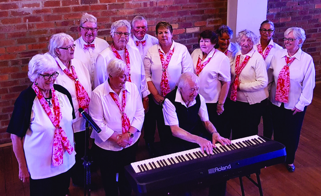 TUNES: Cessnock Seniors Choir pianist Michael Griggs puts the new Roland digital keyboard to the test, surrounded by fellow choir members. Picture: Gray Clack