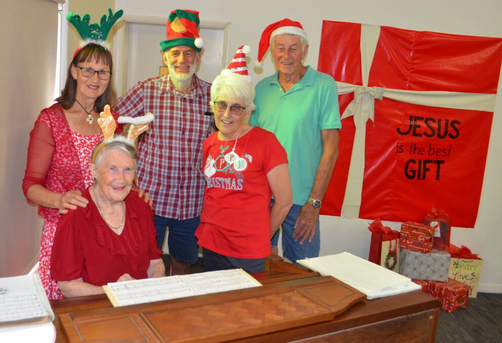 ALL WELCOME: Pictured at left, Cessnock Baptist Church parishioners Barbara Wells, Myra Hill (seated), Les Wells, Helen Fallon and Bill Impey, getting ready for Sunday's Carols night.