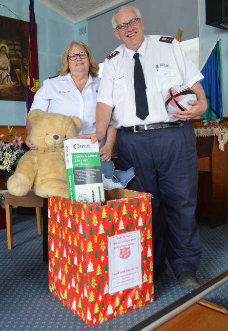 PLEASE GIVE GENEROUSLY: Leanne and Darryn Lloyd from the Salvation Army Cessnock, with donations for this year's Christmas appeal.