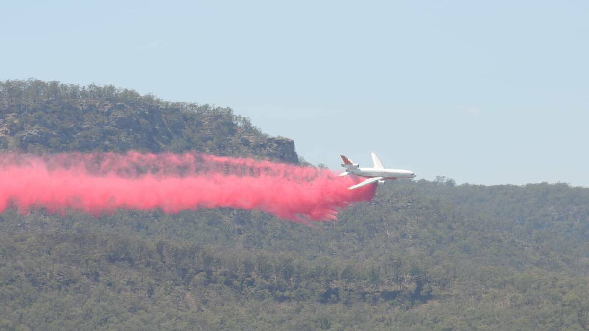 QUITE A SIGHT: A Very Large Air Tanker drops fire retardant over the Owendale fire in Pokolbin State Forest on December 17. Picture: Mike Granger