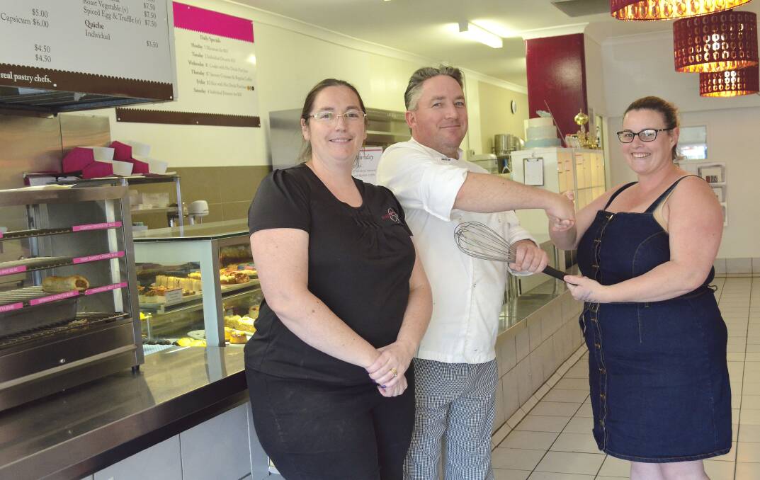 CHANGING HANDS: Rienna and Lennert de Visser, of Exquisite Cakes by Lennert, hand over the whisk to the bakery's new owner Melanie O'Malley of MMM Cakes.