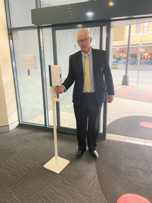 BE RESPONSIBLE: Cessnock mayor Bob Pynsent using the hand sanitiser station at the entry to council's administration building.
