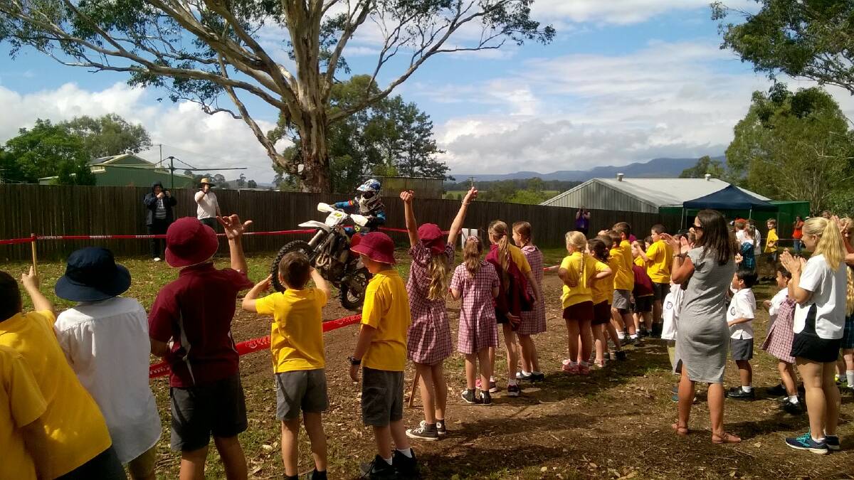 EXCITEMENT: Millfield Public School students cheer on a rider at the Australian Four-Day Enduro checkpoint at the school on Friday.