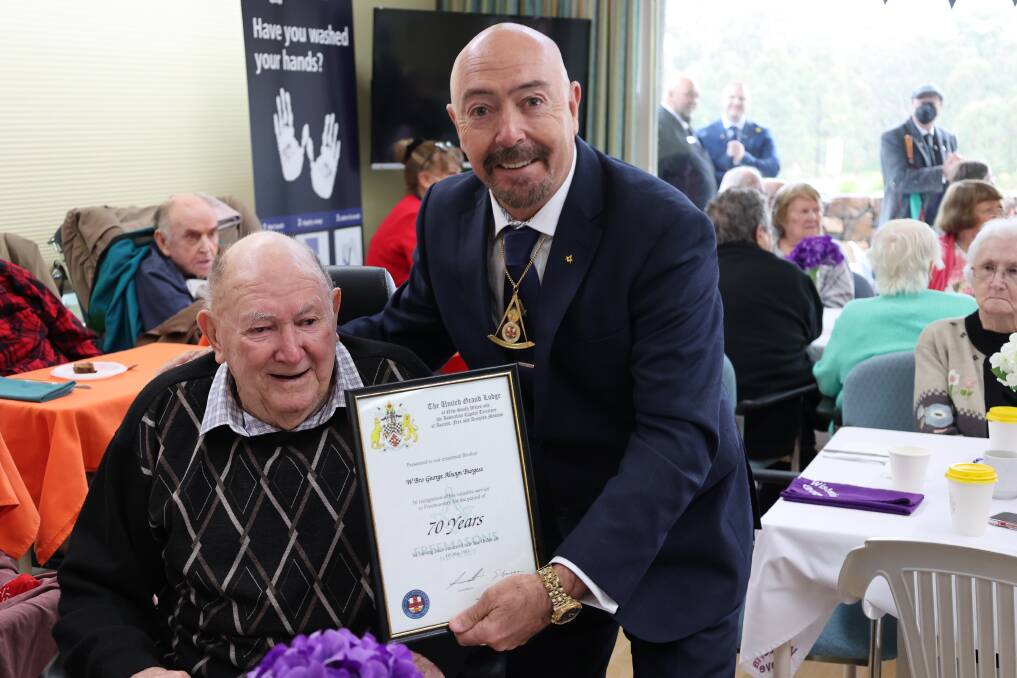 Grand Master Les Hicks presents George Burgess with his 70-year certificate. Picture by Gregory Allen.
