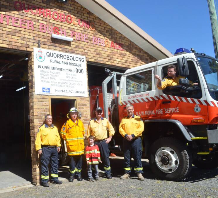 QUICKER: David Hoey, Peter Frame, Kaelan Dodds, Brad Murray, Luke Crump and Darryl Foster (in the truck) at Quorrobolong Rural Fire Station, where they have installed remote controls for the roller doors, thanks to the Celeste Barber fundraiser.
