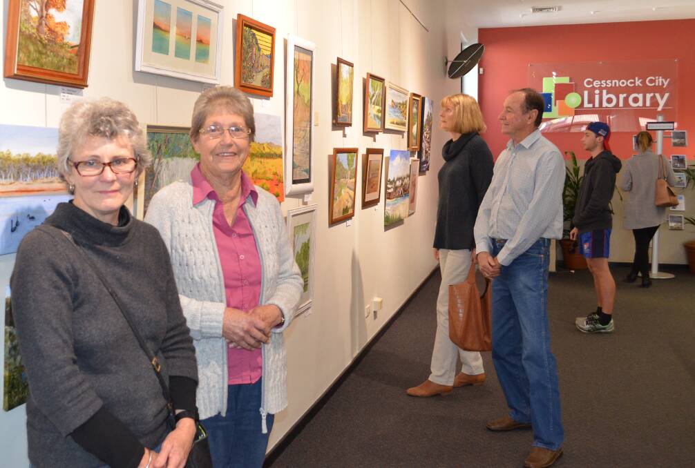 FRIENDLY GROUP: Cessnock Art Group members Lee-Ann Higgison and Margaret Warner with some of the works featured in the group's exhibition at Cessnock Library.