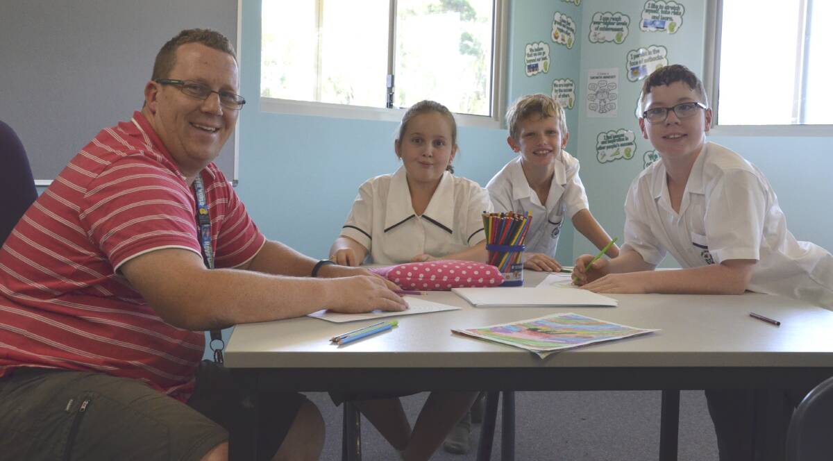 SETTLING IN: DALE Christian School Cessnock teacher Russell Hodges and students Angel Wilson, Blade Hamilton and Mark Thompson in one of the new classrooms at the Nulkaba campus. Picture: Krystal Sellars.