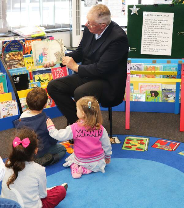 COMMUNITY HUB: Cessnock mayor Bob Pynsent reads to local children at Storytime at Cessnock Library.