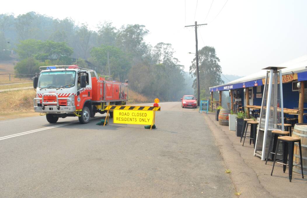 ALERT: A fire truck passes through Wollombi village on the morning of December 10, 2019 as the valley prepared for an intense day of bushfire danger.