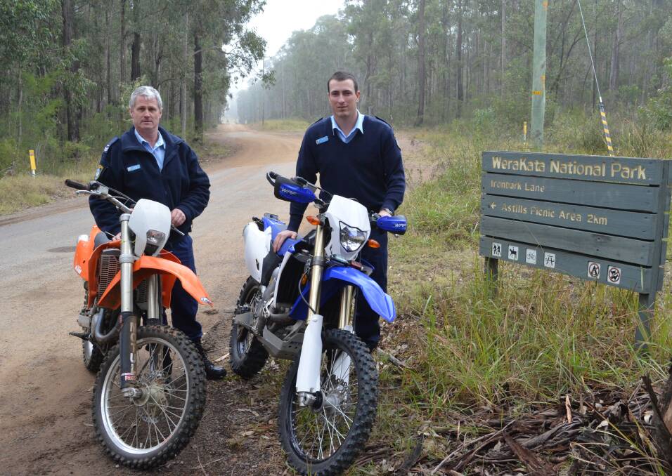 OPERATION: Senior Constable Michael Steele (holding a seized bike) and Constable Rhys Hanlon, from Cessnock Police.