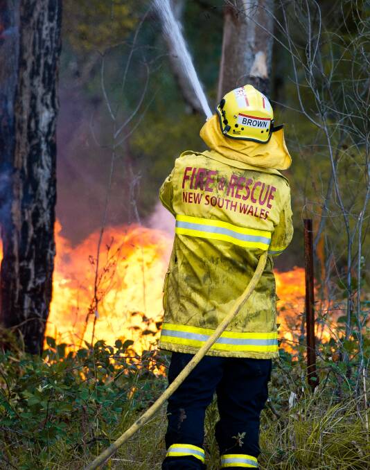BLAZE: A firefighter works to contain the bushfire near Abermain and Neath last week. Picture: Perry Duffin