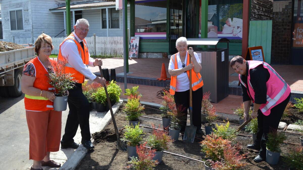 IMPROVEMENTS: Pat Maybury, Cessnock mayor Bob Pynsent, Catherine Parsons and Anne Sander plant some trees in Station Street, Weston.