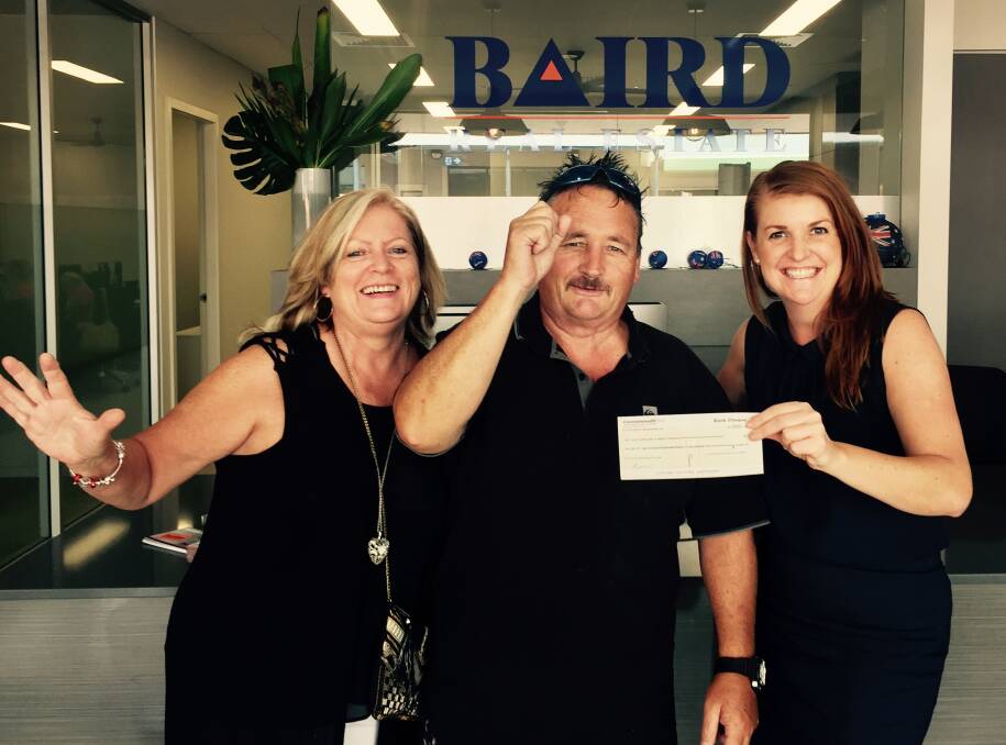 WONDERFUL WIN: Julie and Robert Dykstra receive their $12,000 prize from Baird Real Estate business manager Renee Baird. Picture: supplied
