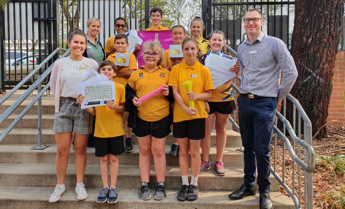 RESOURCES: Woolworths Cessnock representatives pictured with Cessnock Public School staff and students on October 30 when the equipment was delivered.