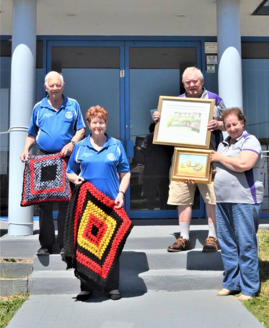 JOINT EVENT: Kurri Sunrise Rotary members Des and Lynn Mills and Towns With Heart's Graham Smith and Sharon Dyson-Smith getting ready for the festival.